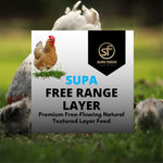 A promotional graphic for 'Supa Free Range Layer' textured layer feed by Supa Feeds, featuring a central white and gray text panel with a chicken illustration and the brand logo, set against a blurred background of chickens in a grassy field.