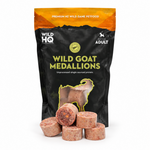 A black stand-up pouch of Wild HQ Wild Goat Medallions pet food, with several round raw meatballs displayed in front on a white background.