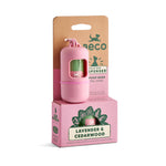 A pink Reco poop bag dispenser with a floral clip, shown in front of its brown cardboard backing card and pink retail box labeled Lavender & Cedarwood.