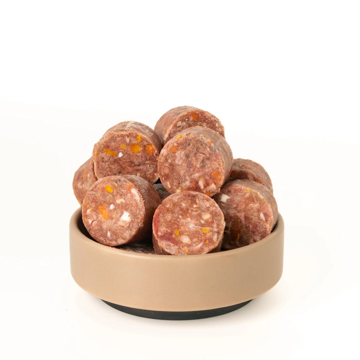 Bowl filled with round sausages on a white background