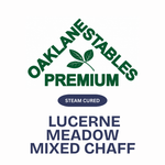 A clean white graphic with the text 'OAKLANESTABLES PREMIUM' in dark green, a small green leaf logo, a dark blue oval reading 'STEAM CURED,' and large dark blue text reading 'LUCERNE MEADOW MIXED CHAFF.'.