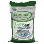 A green and white bag of Dunstan Betabeet Flakes horse feed.