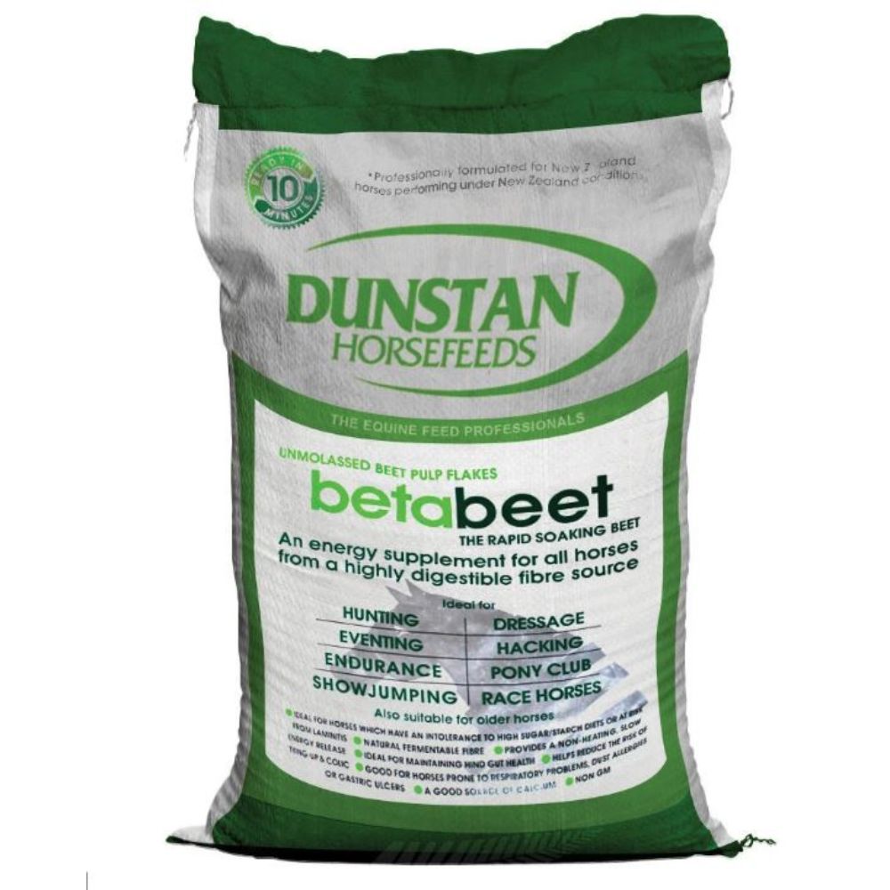 A green and white bag of Dunstan Betabeet Flakes horse feed.