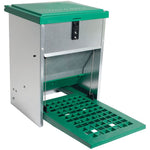 A poultry feeder with a green and gray body, featuring a step plate and a shutter mechanism.